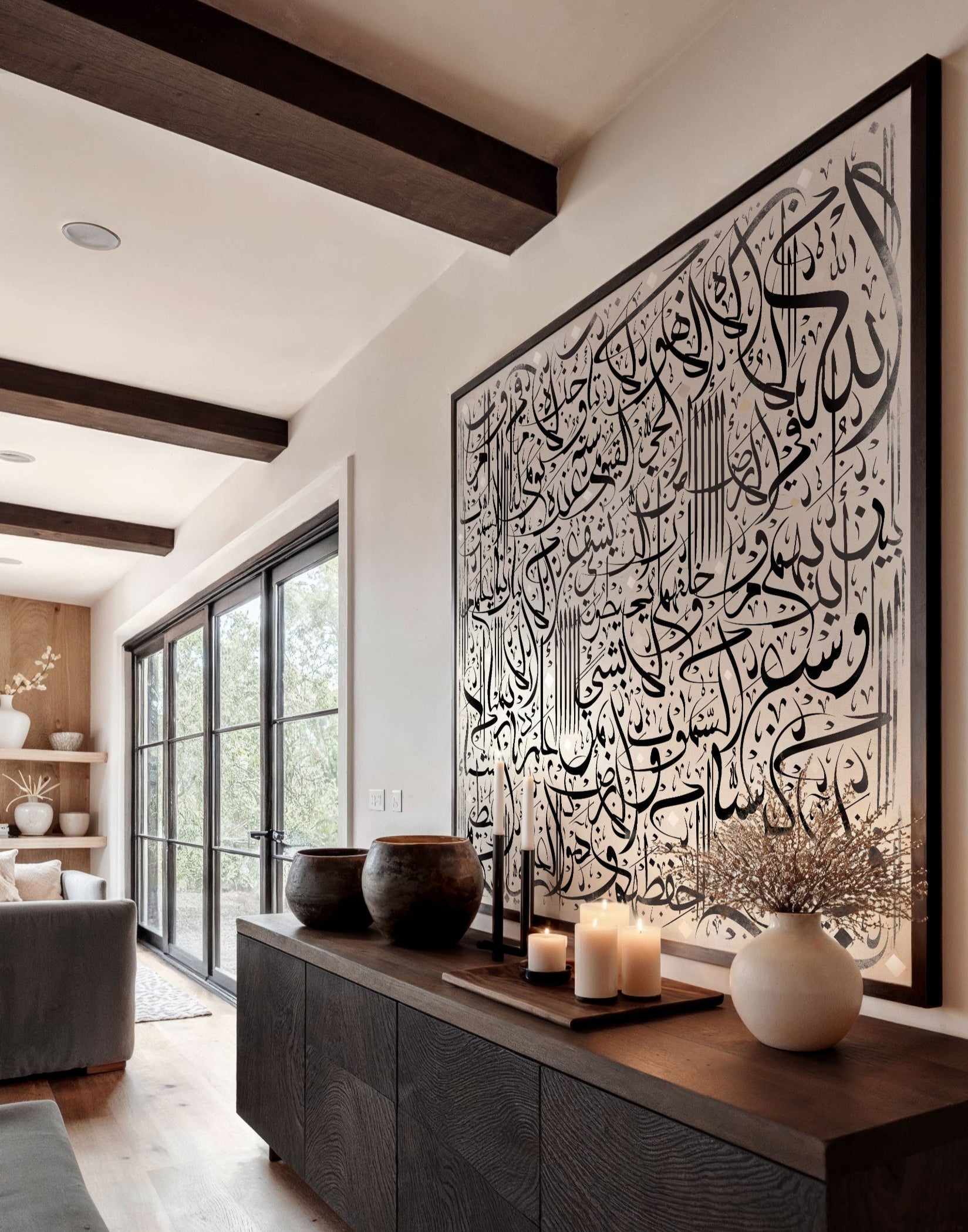 Modern interior with a large wall art piece featuring Arabic calligraphy.