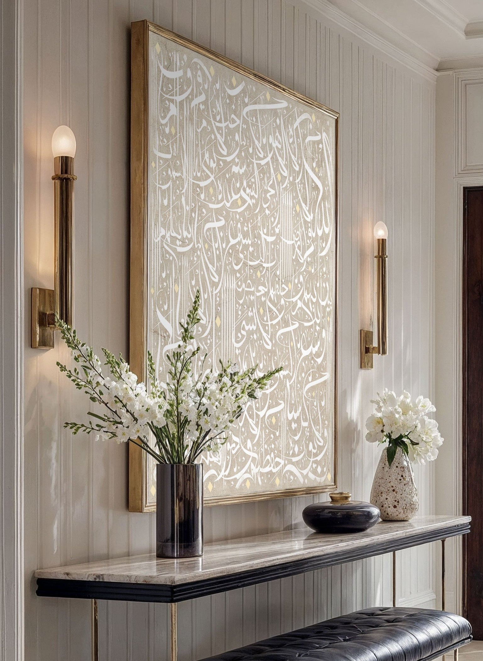 Modern interior with a console table, black bench, and Arabic calligraphy wall art.